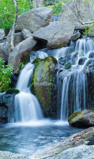 A long exposure shot of waterfall flowing down from rock formations