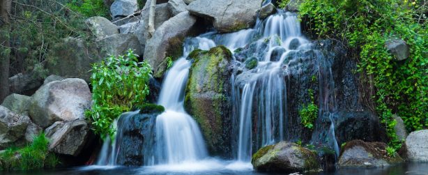A long exposure shot of waterfall flowing down from rock formations